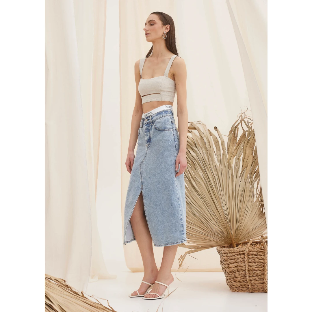 GAIA DENIM SKIRT LIGHT BLUE Meet the icon GAIA denim skirt in light blue. This midi denim skirt is the most fashionable piece of the season