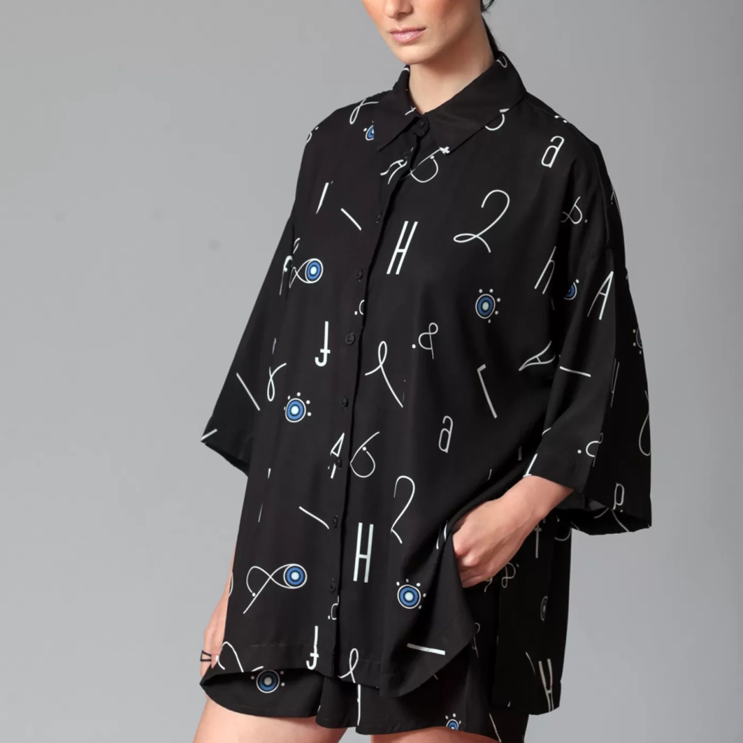 button-up front and a patch pocket at the front. Modern unisex shirt with Alphabet print